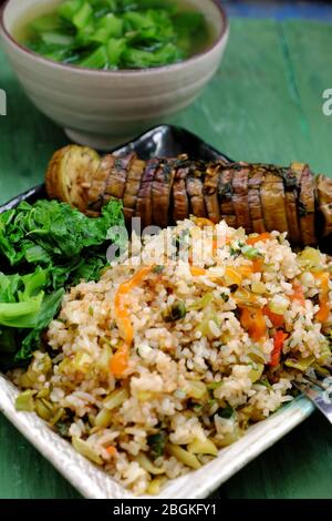 plate of vegan food, mixed fried rice with vegetables, baked eggplant, healthy nutrition meal for lunch time of homemade Vietnamese vegetarian Stock Photo