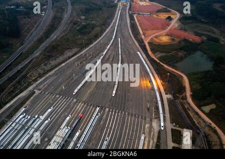 An aerial view of high-speed trains gathering at night after ...