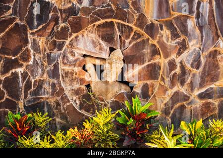 Statue of a Balinese woman and tropical foliage, Bali, Indonesia Stock Photo