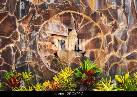 Statue of a Balinese woman and tropical foliage, Bali, Indonesia Stock Photo