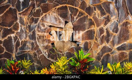 Statue of a Balinese woman and tropical foliage, Bali, Indonesia Stock Photo