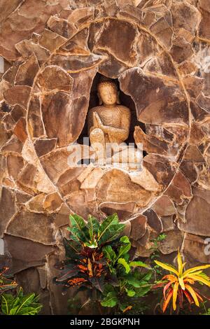 Statue of a Balinese woman and tropical foliage, Bali, Indonesia Stock Photo