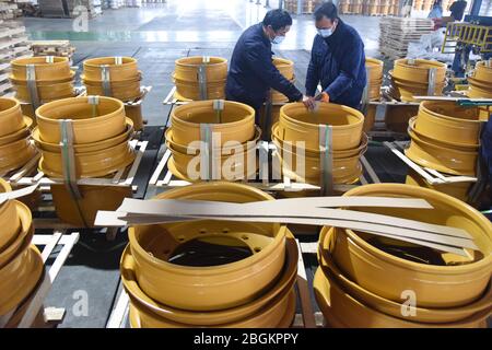 Staff work to produce wheel hubs at a local steal factory to meet the demands of overseas customers, Donghai county, Lianyungang city, east China's Ji Stock Photo