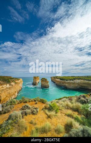 Loch Ard Gorge enclosed bau with steep limestone surrounding cliffs and two pinnacles in vertical composition. Stock Photo
