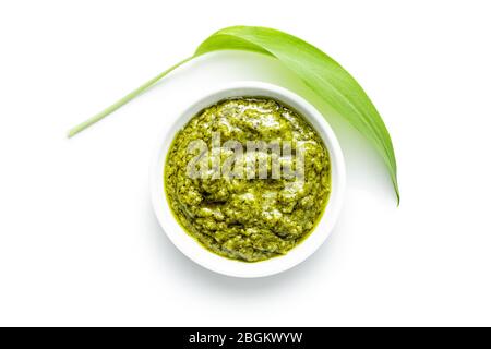 Wild garlic pesto and green ramsons leaves isolated on white background. Stock Photo