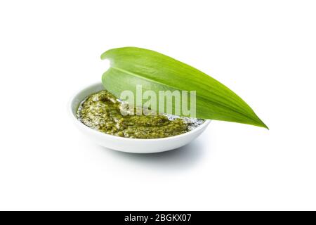 Wild garlic pesto and green ramsons leaves isolated on white background. Stock Photo