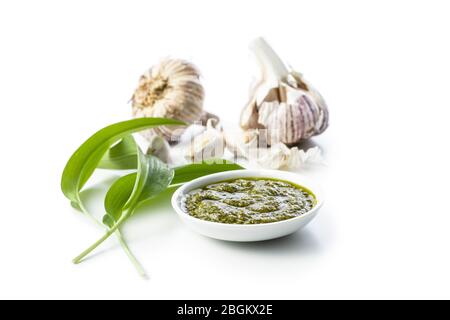 Wild garlic pesto and green ramsons leaves isolated on white background. Stock Photo
