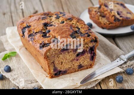 Banana bread on old wooden rustic table, slice of cake with banana, close up Stock Photo