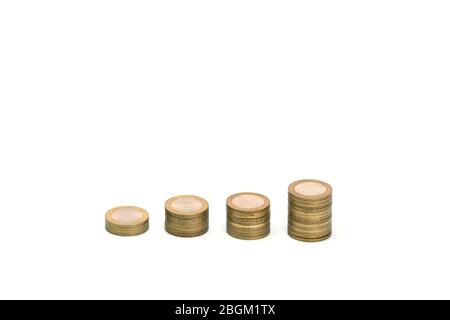 Piles of golden metallic coins. Columns of coins of different heights. The concept of business, economy, finance, investment and prices. Place for text and background for design. Stock Photo