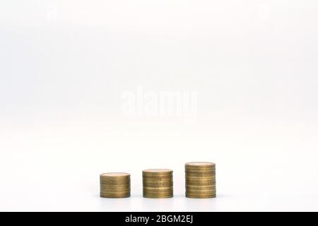 Piles of golden metallic coins. Columns of coins of different heights. The concept of business, economy, finance, investment and prices. Place for text and background for design. Stock Photo