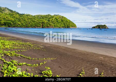 View of a volcanic beach on the pacific coast of central America. Playas del Coco, Costa Rica. Guanacaste province.