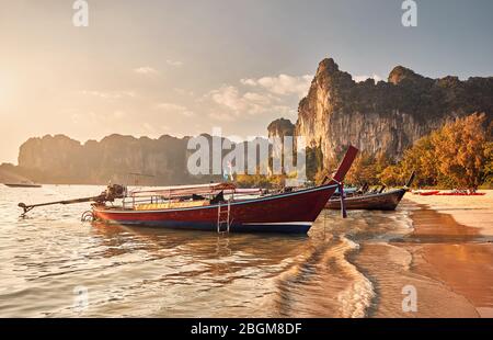 Long tail boats on tropical beach at beautiful sunset in Krabi, Thailand Stock Photo