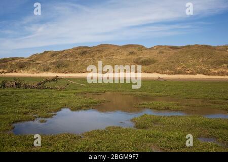 Flooded grass area abutting Ogmore river in Merthyr Mawr nature reserve Stock Photo