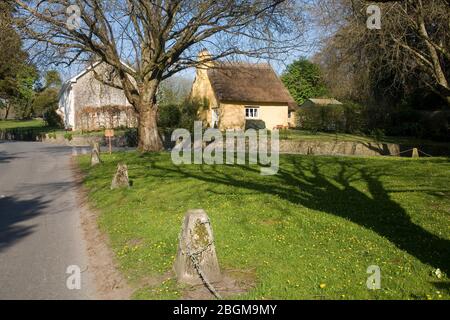 green at the centre of the village of Merthyr Mawr with thatched and unthatched cottages on a sunny spring afternoon Stock Photo