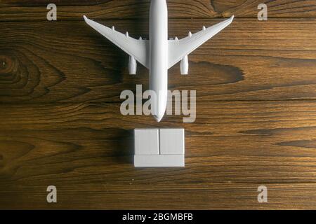 Airplane with wooden cubes on which you can enter your date stands on a wooden table Stock Photo