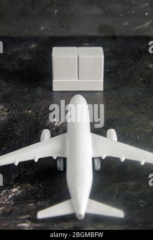 Airplane with wooden cubes on which you can enter your date stands on a dark background. Top views Stock Photo
