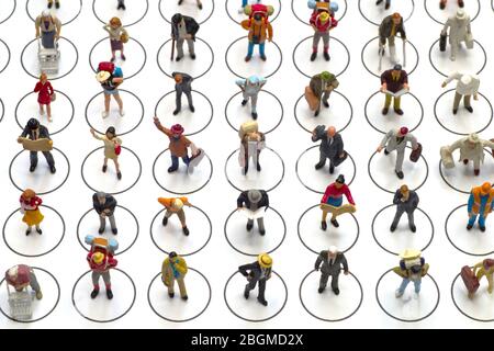 Top view, from above miniature toys - social distancing conceptual image, people distancing each other in public places to avoid infection. Stock Photo