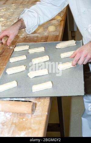 Baker preparing chocolate croissant Stock Photo