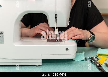 Woman sewing using a sewing machine Stock Photo