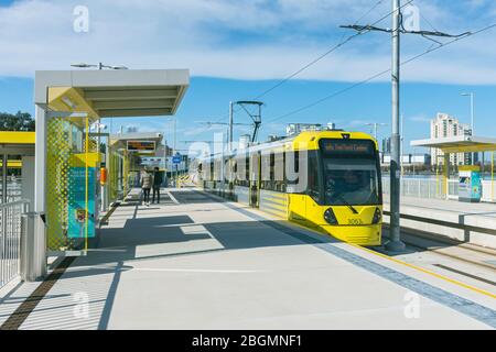 Metrolink tram at the Wharfside stop on the opening day of the Trafford Park Line, 22 March 2020.  Wharfside, Old Trafford, Manchester, UK Stock Photo