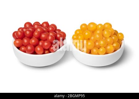Bowls with fresh red and yellow Tomberry tomatoes close up isolated on white background Stock Photo