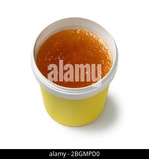 Old fashioned soft brown detergent soap in a plastic container isolated on white background Stock Photo