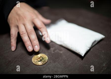 Man gets Bitcoin for drugs. Concept of doggy crypto currency. Stock Photo