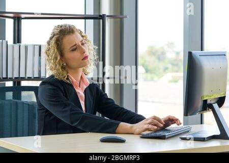 Morning work atmosphere In a modern office. Ukrainian employees ponder on what to report to their supervisor. After clearing the remaining pending wor Stock Photo
