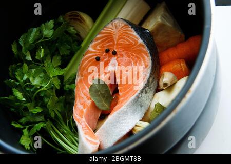 Food preparation. Raw salmon with vegetables in a pan. Healthy eating concept. Healthy lifestyle. Vegetarian food. Stock Photo