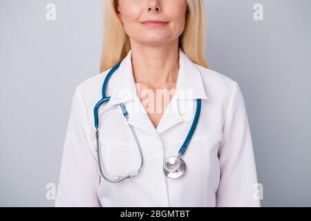 Cropped photo of qualified old woman practitioner with stethoscope ready examine consult corona virus patient isolated over gray color background Stock Photo