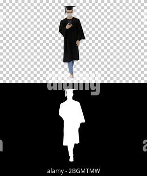 Young man with graduation gown walking in medical mask using sma Stock Photo