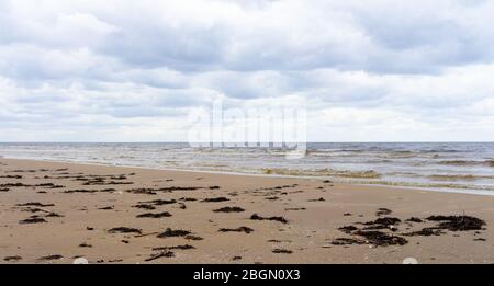 Clouds on a cloudy sky over the sandy beach of the Baltic Sea in Jurmala Stock Photo