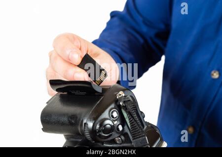man inserting a memory card in a reflex camera Stock Photo