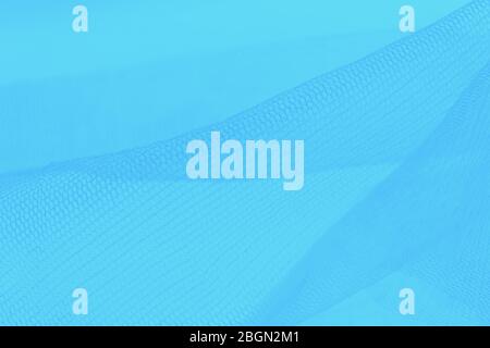 Light small mesh fabric on blue background Stock Photo