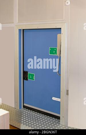 Insulated Blue Door at Reefer Refrigerator Storage Room Stock Photo