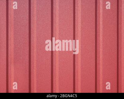 Detail of new red metal fence with vertical ribs of rigidity Stock Photo