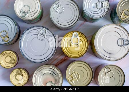 Overhead view row canned food in different sizes and colors. Stock non-perishable preserved food Stock Photo