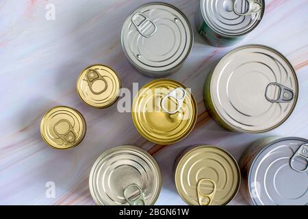 Overhead view row canned food in different sizes and colors. Stock non-perishable preserved food Stock Photo