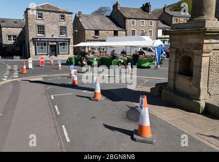 Covid-19 social distancing at one of the few stalls present on Tuesday market day in Settle, North Yorkshire, UK Stock Photo