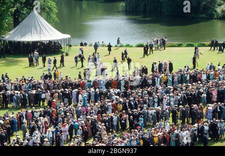 HM The Queen's guests gather at a grand Garden Party held on the lawns in the back garden of Buckingham Palace London, England. The official residence Stock Photo