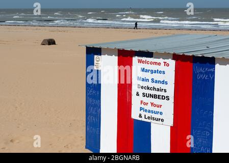 Handwritten signs on the deckchair rental booth advising people not to sit down on Margate sands during Covid-19 lockdown, April 2020 Stock Photo