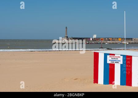 Handwritten signs on the deckchair rental booth advising people not to sit down on Margate sands during Covid-19 lockdown, April 2020 Stock Photo