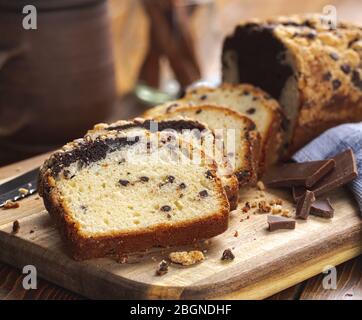 Closeup of sliced chocolate marble loaf cake on a wooden cutting board Stock Photo