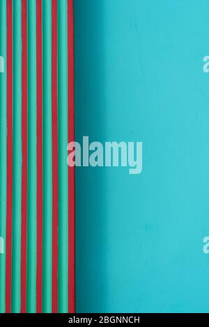 part of striped line of red green on colorful bright blue cement or concrete wall architecture abstract geometric background Stock Photo