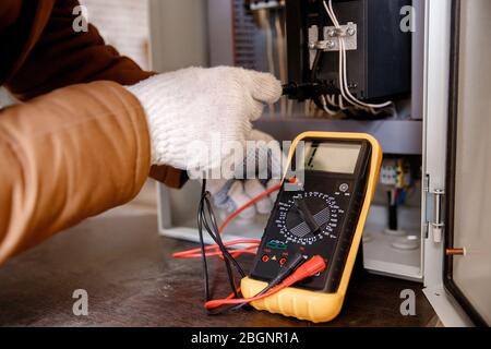 Checking electrical panel and power cable for short circuit Stock Photo