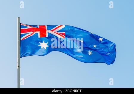 Waving colorful Australia flag on blue sky Stock Photo