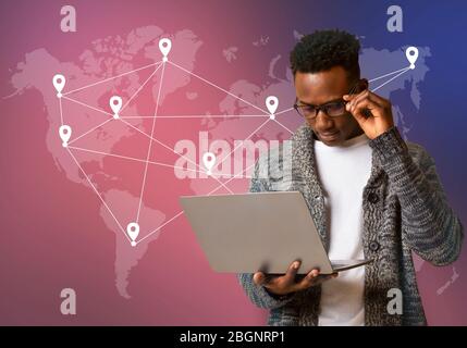 Black hacker holding laptop with virtual display server data Stock Photo