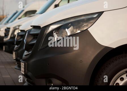 Cars in row for sale Headlight grill bumper and hood of a commercial vehicle in white Stock Photo