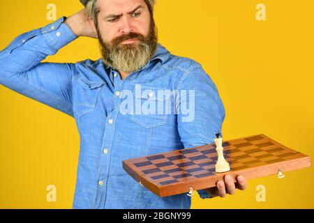 Chess figure. Intellectual game. Grandmaster player. Chess lesson. Cognitive development. Enjoy tournament. Strategy concept. Chess competition. Board game. Thoughtful bearded man play chess. Stock Photo