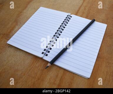 empty white paper/book on wooden background Stock Photo